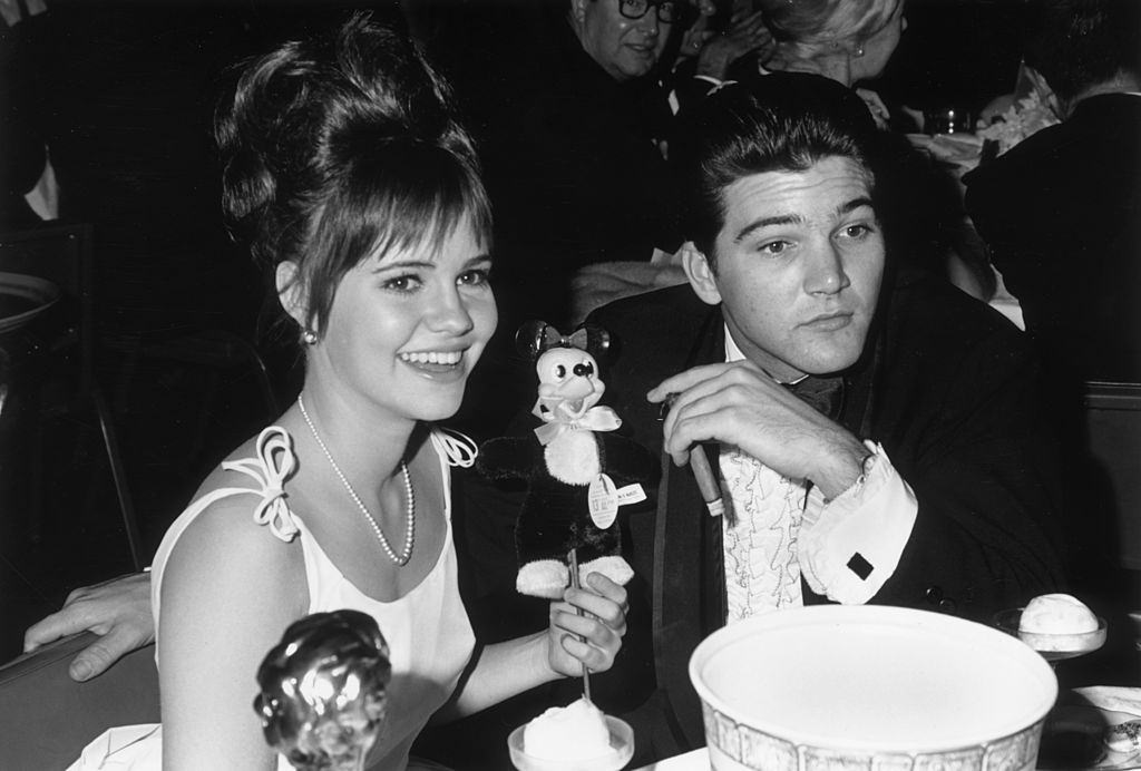 #12 Sally Field and her date, Paul Peterson, seated at a Hollywood event, 1966