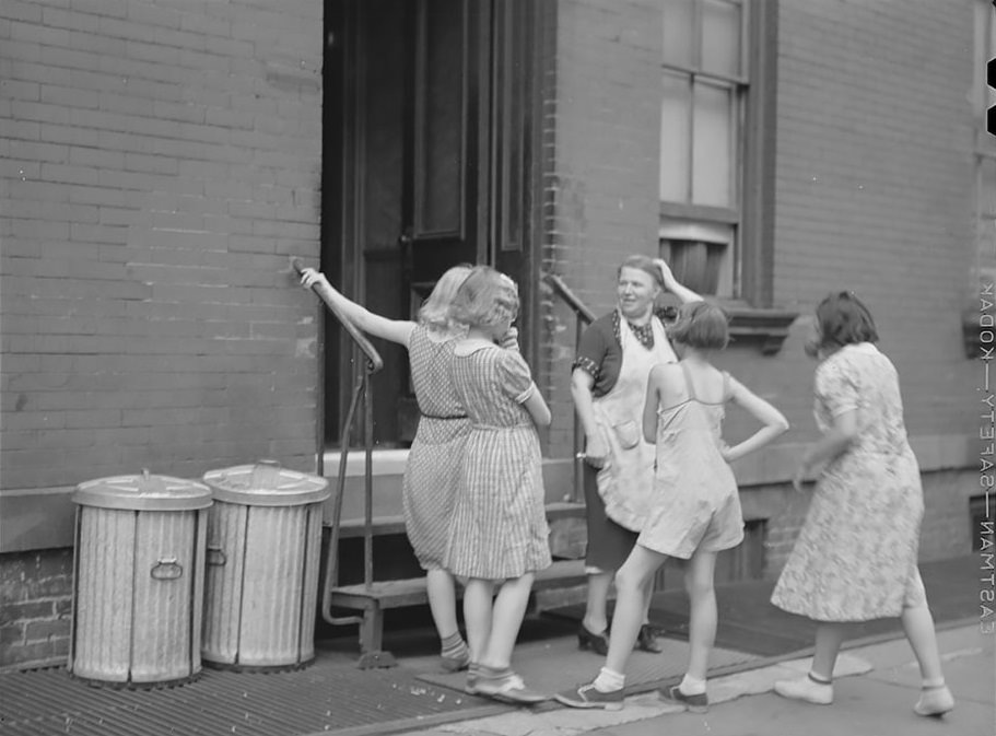#34 A woman and girls at the back of an apartment house on East 63rd Street