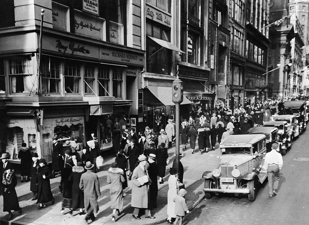 #12 View of pedestrian and vehicle traffic at the intersection of 42nd Street and 5th Avenue, New York City, 1930s.