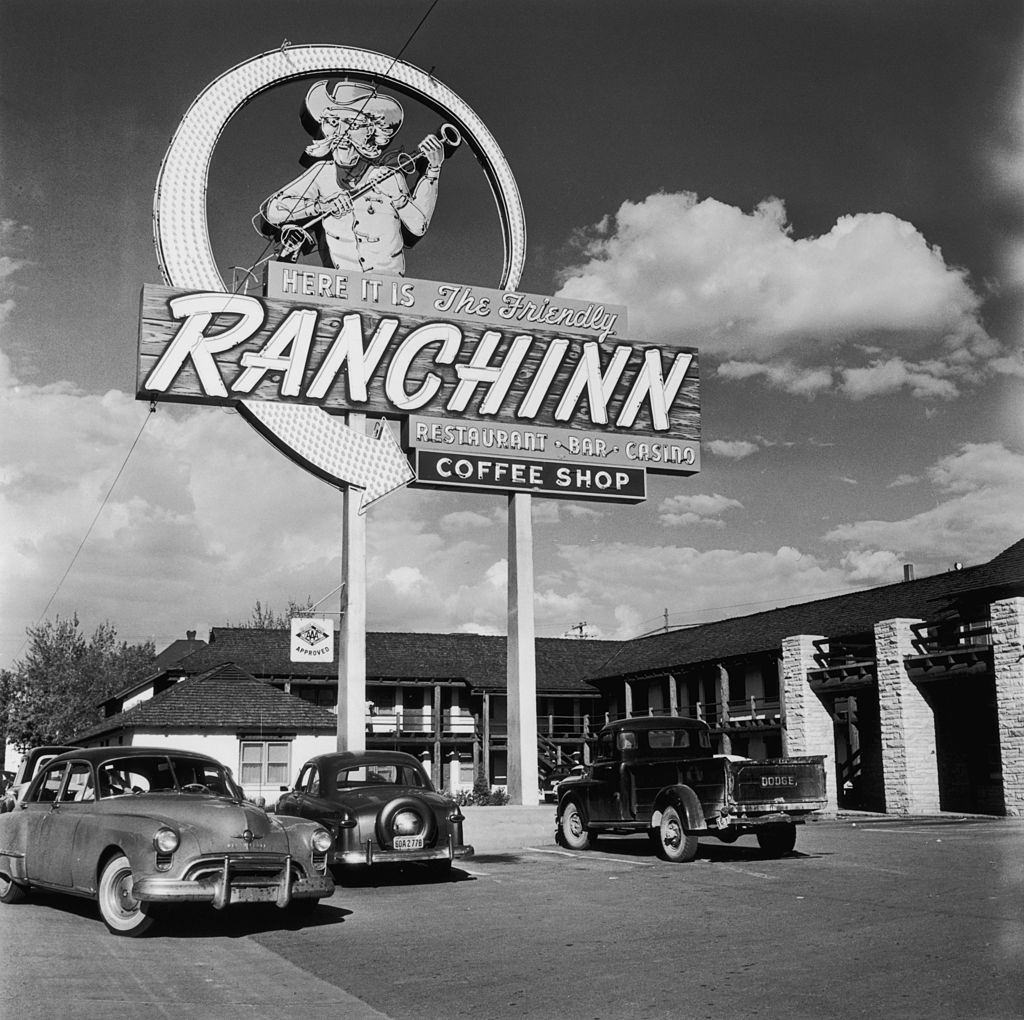 #25 A large neon arrow sign outside the ‘Ranchinn’ restaurant, bar, casino and coffee shop in Las Vegas, 1952