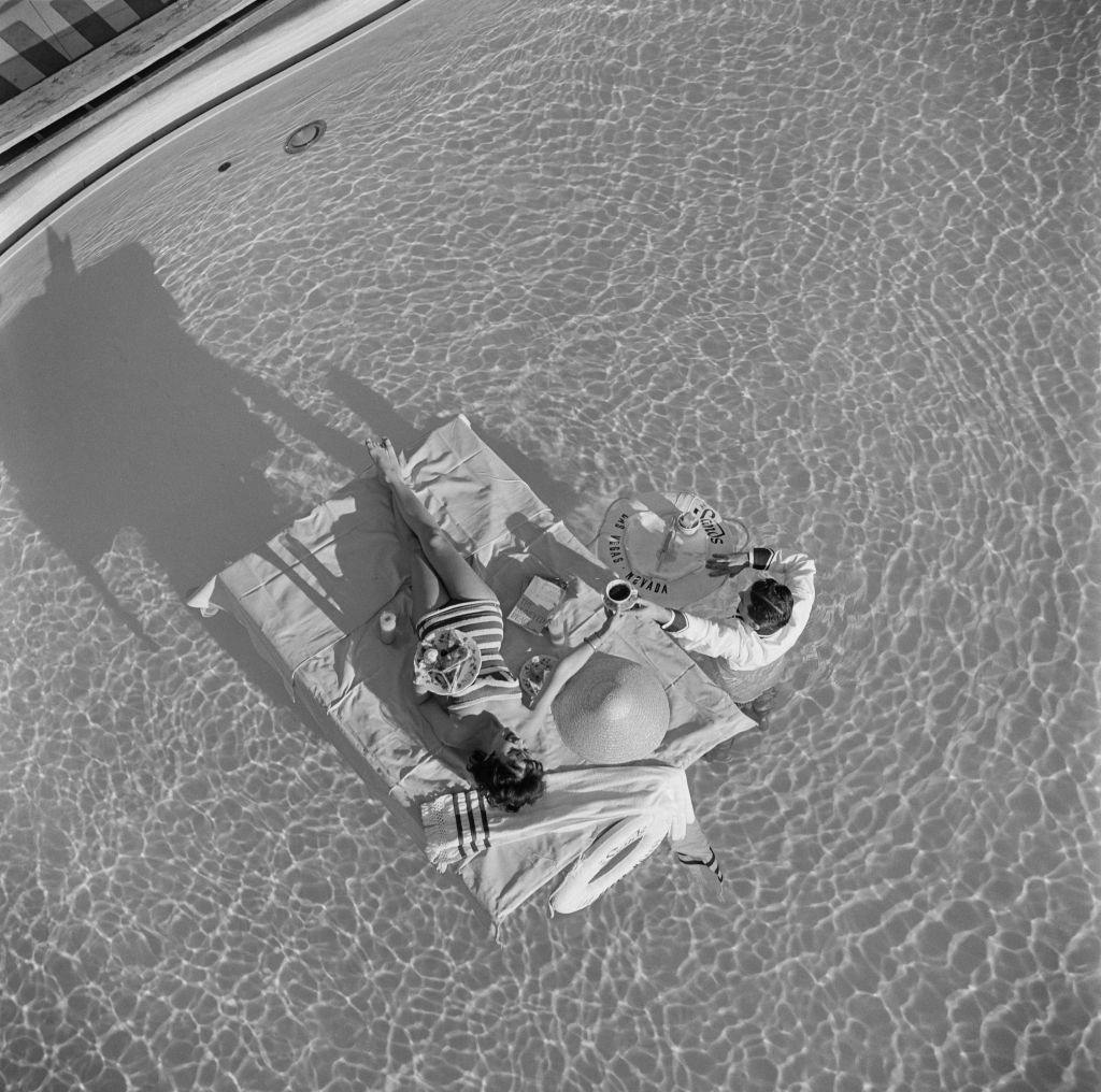 #38 Austrian actress Mara Lane enjoys waiter service in the pool at the Sands Hotel, Las Vegas, 1954.