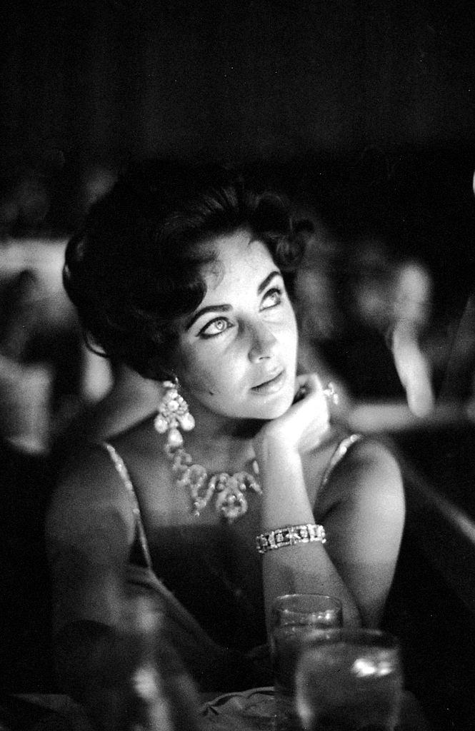 #42 Actoress Elizabeth Taylor watches her fiance Eddie Fisher as he performs on stage at the Tropicana in Las Vegas, 1959.