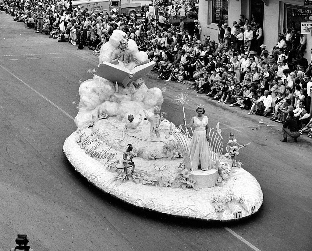 #55 Elevated view of the ‘Queen of Las Vegas’ float as it drives past onlookers during the Hellolorado Parade, Las Vegas, 1950.