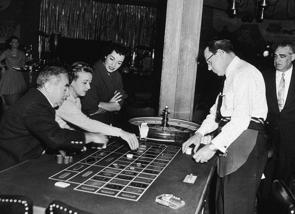 #60 American opera singer, Marguerite Piazza, watching guests play roulette at the Sands Hotel in Las Vegas, 1955.