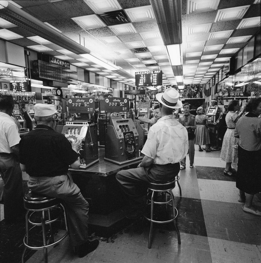 #8 View of patrons as they play slot machines at the Glittering Gulch Casino, Las Vegas, 1955.