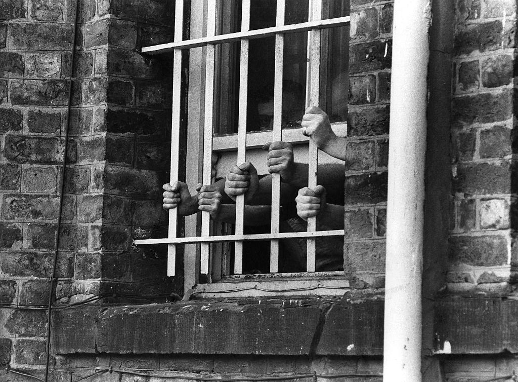 #18 Hands at the bars of a window at Liverpool’s Walton Prison, 1975.