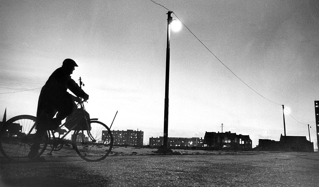 #34 A cyclist taking a break as he rides through wasteland in Everton, bordered by Breck Road and Heyworth Street, Liverpool, 1976.