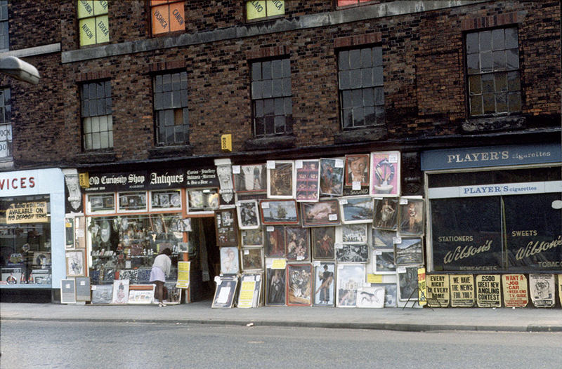 #16 Display of posters and reproduction paintings outside the Old Curiosity Shop on Chapel Street, Salford, September 1973.