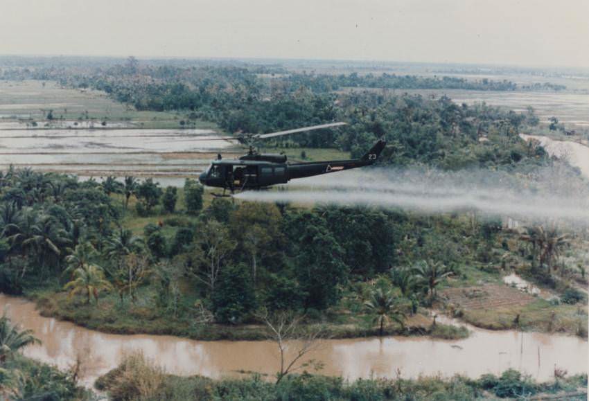 #48 A helicopter sprays Agent Orange, Vietnam, 1969