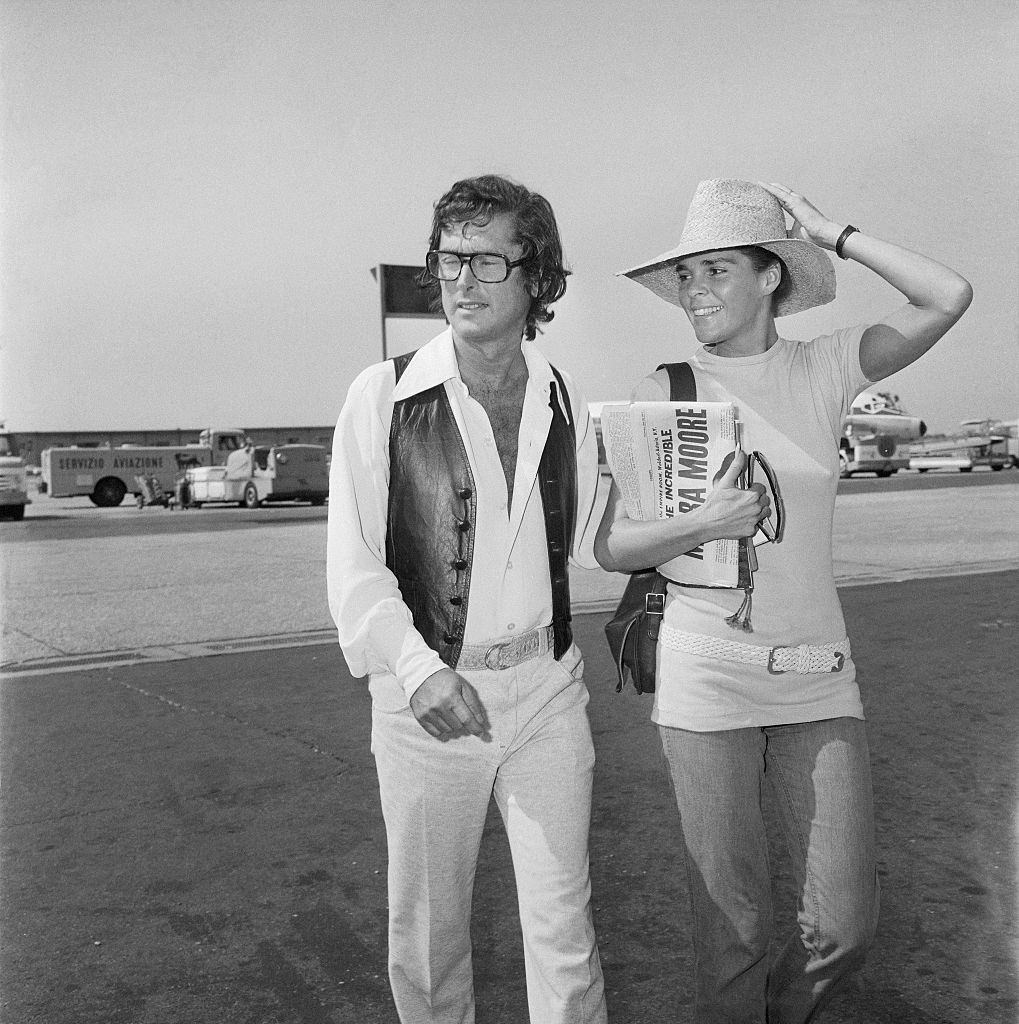 #33 Ali MacGraw with her Husband Robert Evans at Airport, 1971