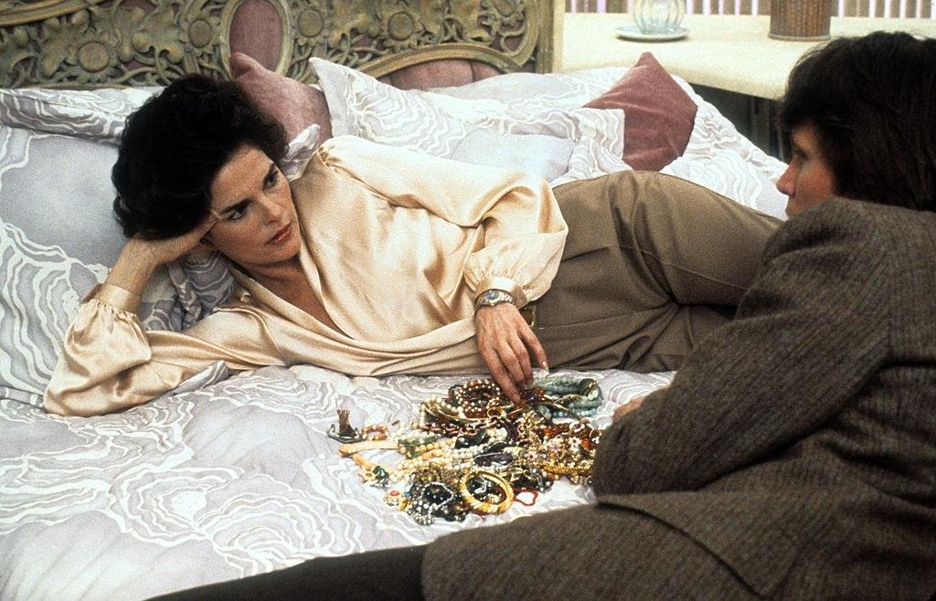 #7 Ali MacGraw lies in a scene from the film ‘Just Tell Me What You Want’, 1980.