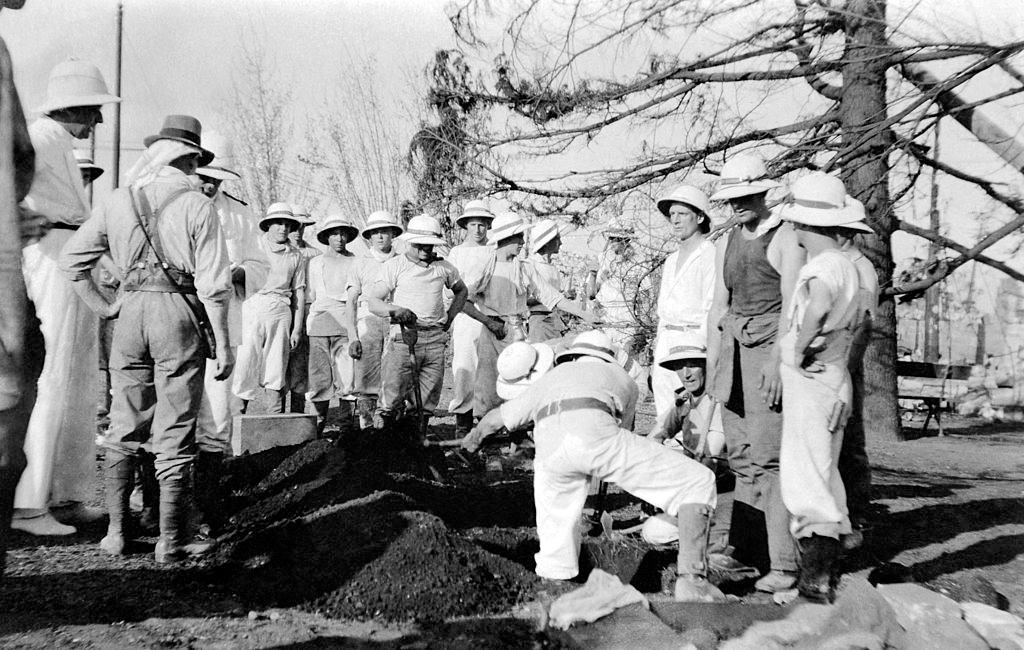 #5 A burial during a funeral after the Tokyo earthquake in Japan, circa 1923.