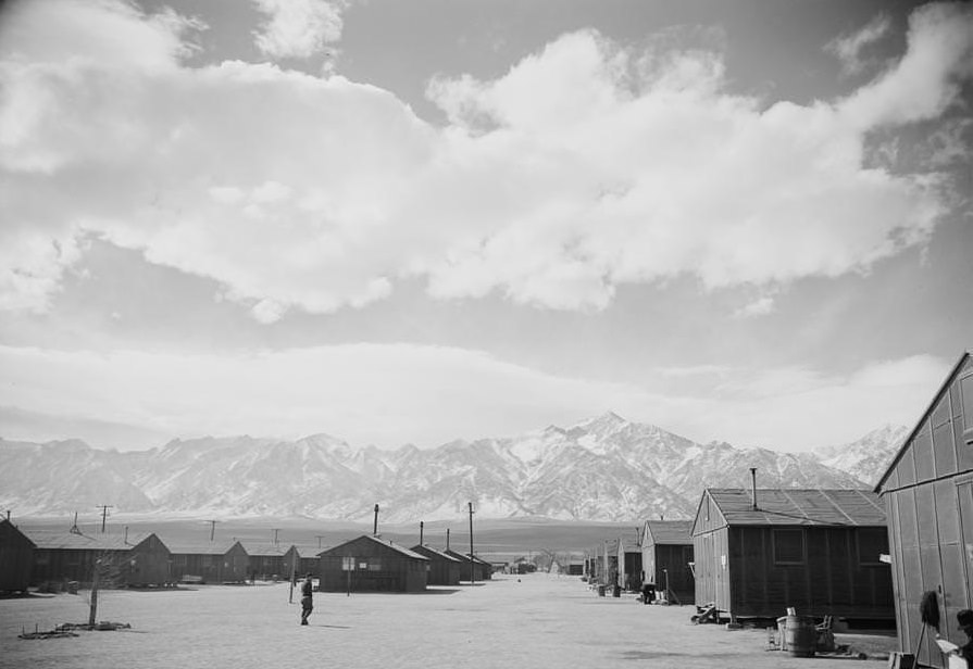 #13 Rows of camp houses at the base of mountains.