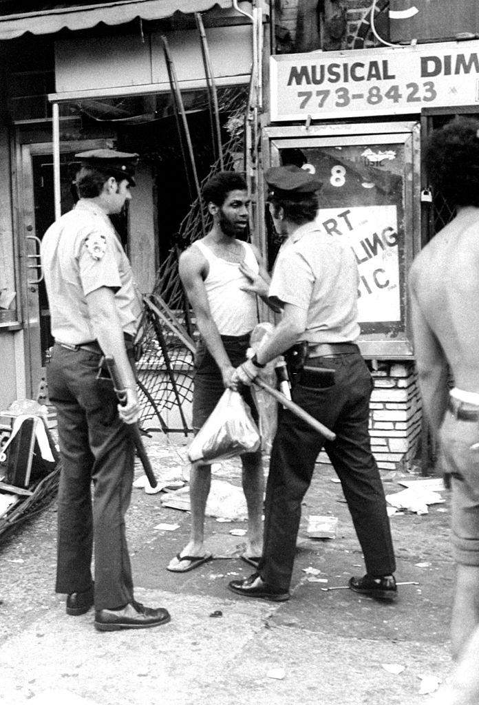 #14 Looter is arrested during 1977 Blackout Power Failure at Utica and Eastern Parkway, New York City, 1977.