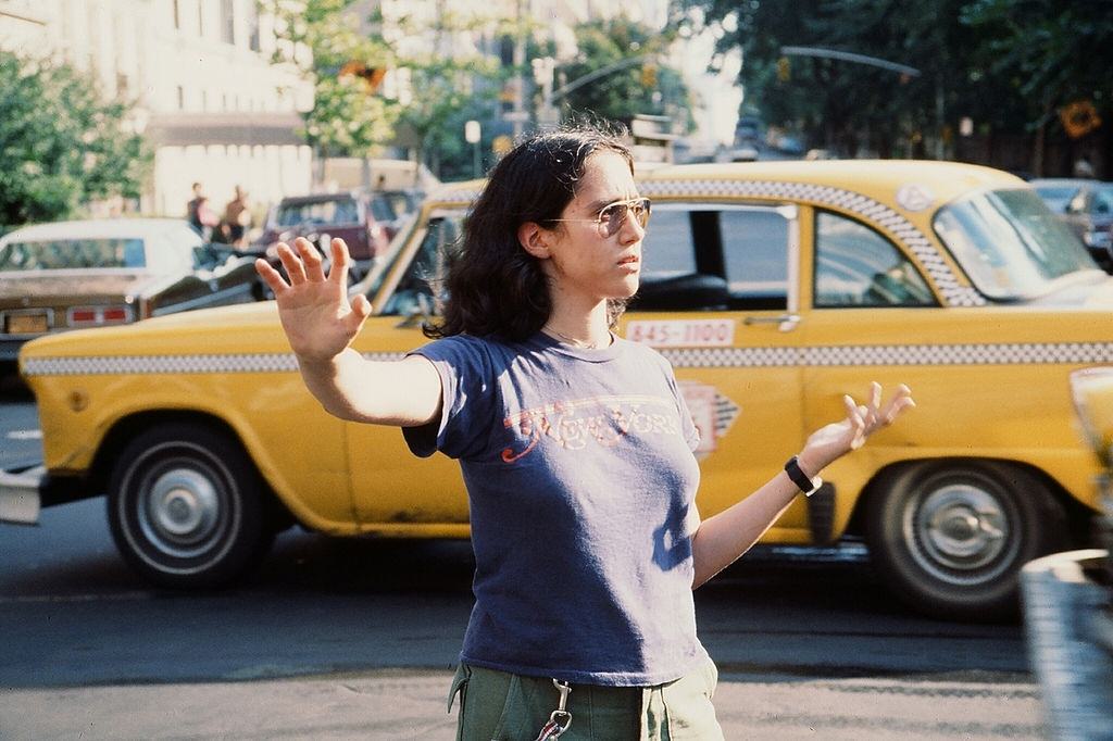 #4 A young woman directing traffic in the wake of the New York City blackout, 1977.
