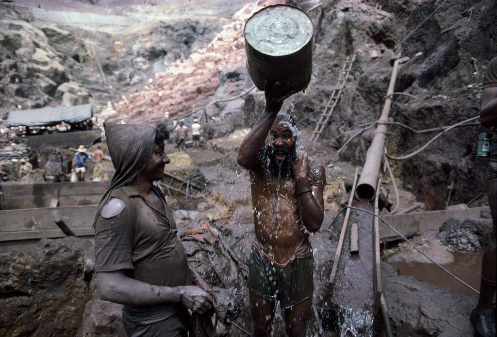 #20 A miner bathe on the edge of an open pit gold mine in Serra Pelada, Brazil.