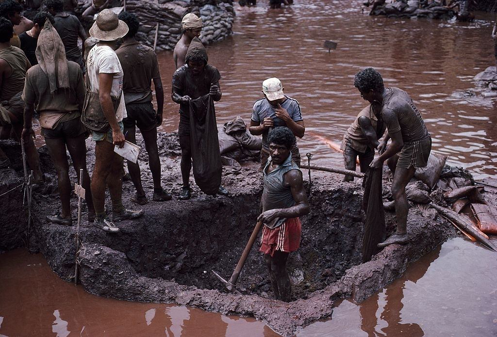 #22 Mine workers dig ore from a plot at the bottom of the Serra Pelada, Brazil gold mine.