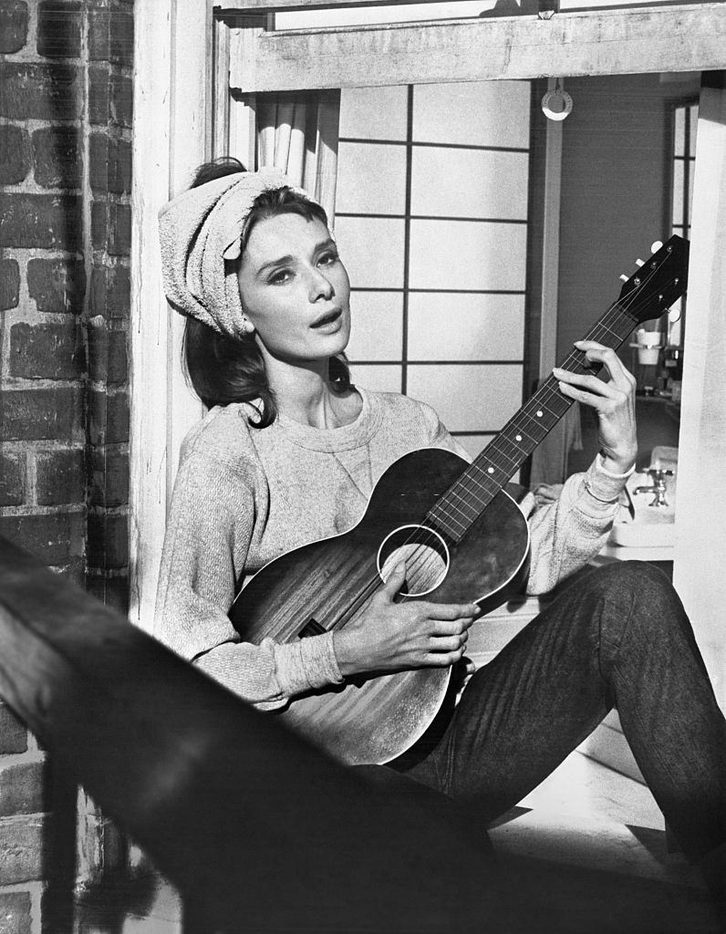 #26 Audrey Hepburn playing guitar