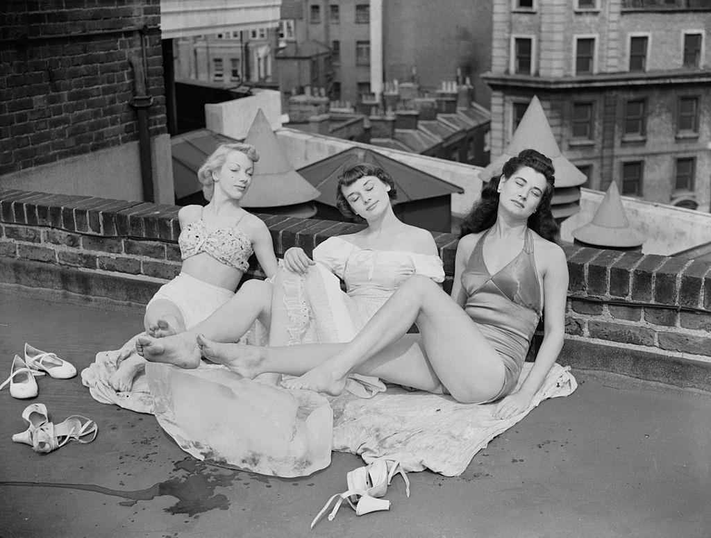 #31 Audrey Hepburn with Aud Johanssen and Enid Smeedon relaxing on the roof of the theatre, 1949.