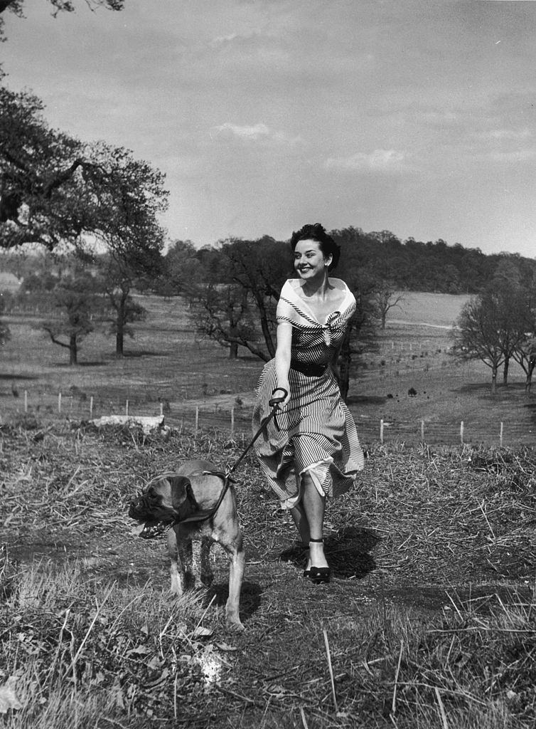 #55 Audrey Hepburn exercising her dog in Richmond Park, May 1950.