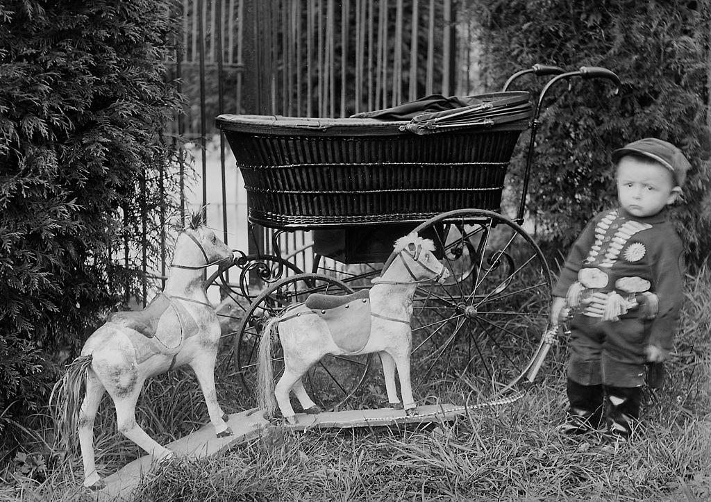 #32 Toddler boy with his toy horses in Belgium, 1901.