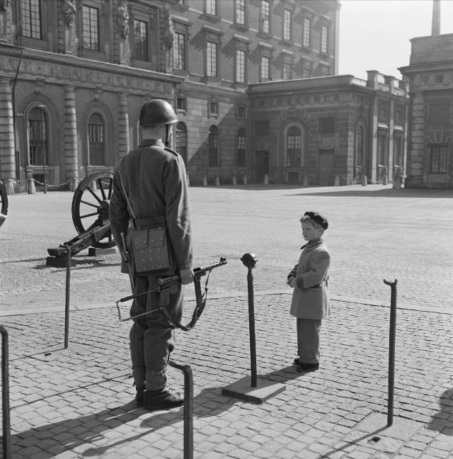 #17 Crown Prince Carl Gustaf with a guard at the Stockholm castle courtyard.