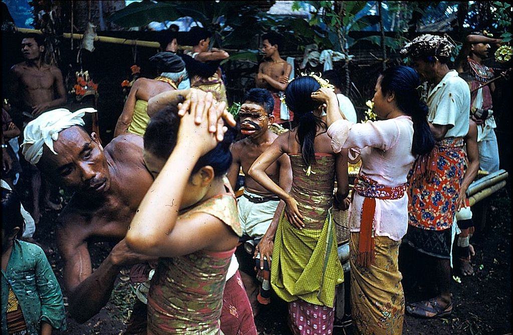 #17 Balinese women dancers are helped to dress and make up, 1956.