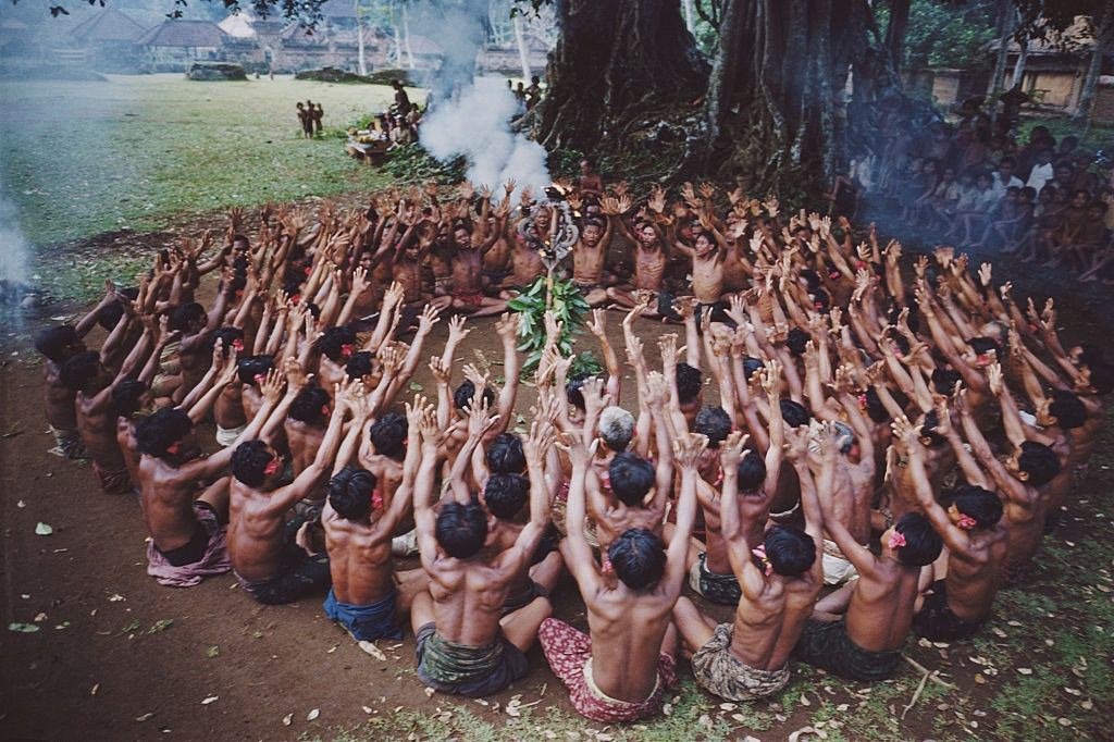 #66 A circle of men sway in unison during a kecak dance, a modern variation of an ancient sanghyang trance dance. Bali, 1956.
