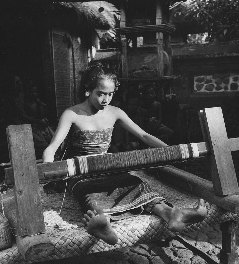 #35 The daughter of a village headman weaving a sarong in Bali, 1954.