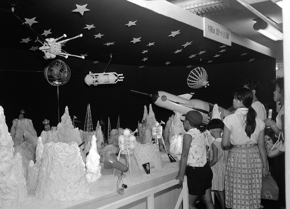 #30 Japanese children press close to view an “outer world” space exhibit in a Tokyo department store on August 19, 1958.