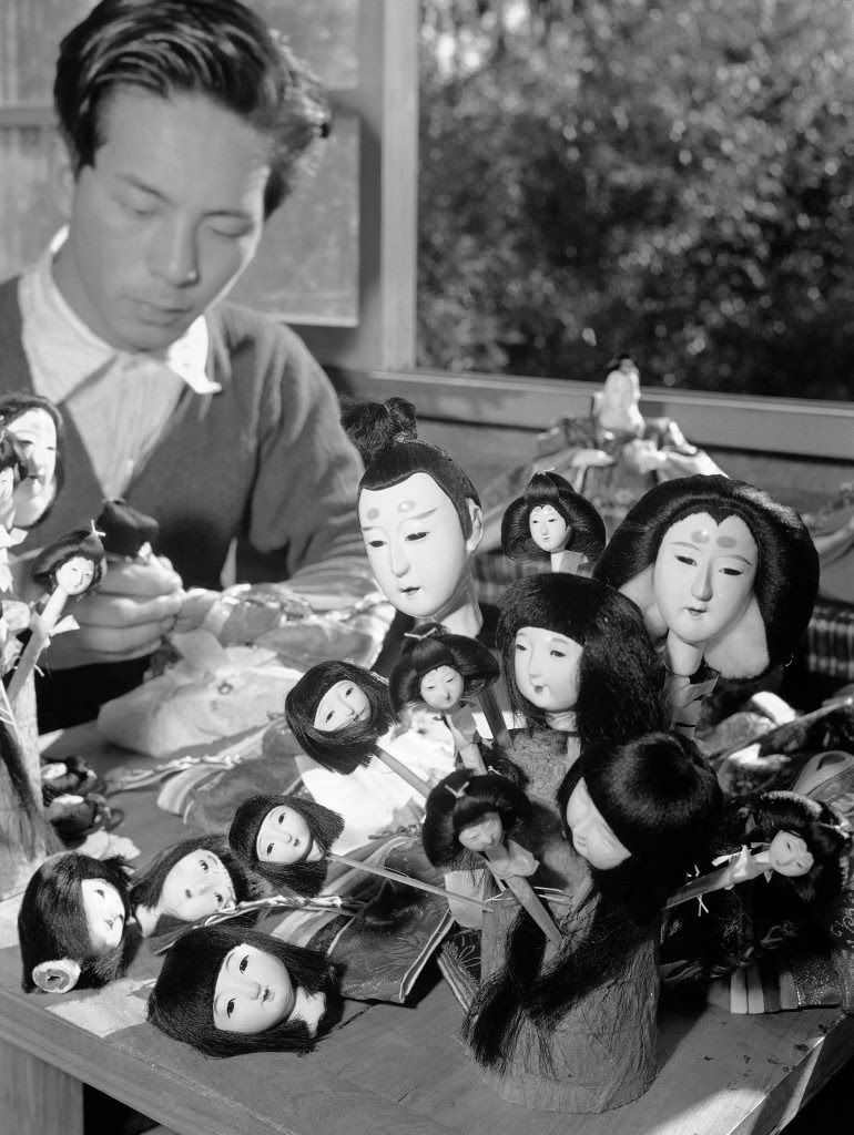 #48 The heads all painted and the hair glued on, this Tokyo doll maker gets dolls ready for dressing in Tokyo on Jan. 26, 1950.