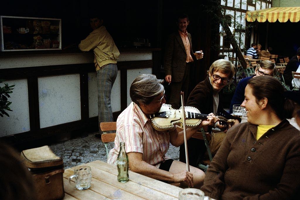 #6 Woman playing a fiddle in a cafe, Ireland, 1960.