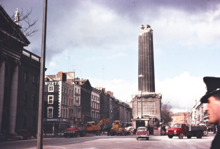 #15 A half-demolished Nelson’s Pillar on O’Connell Street, Dublin. From the front page of the Irish Times on Tuesday, 8 March 1966
