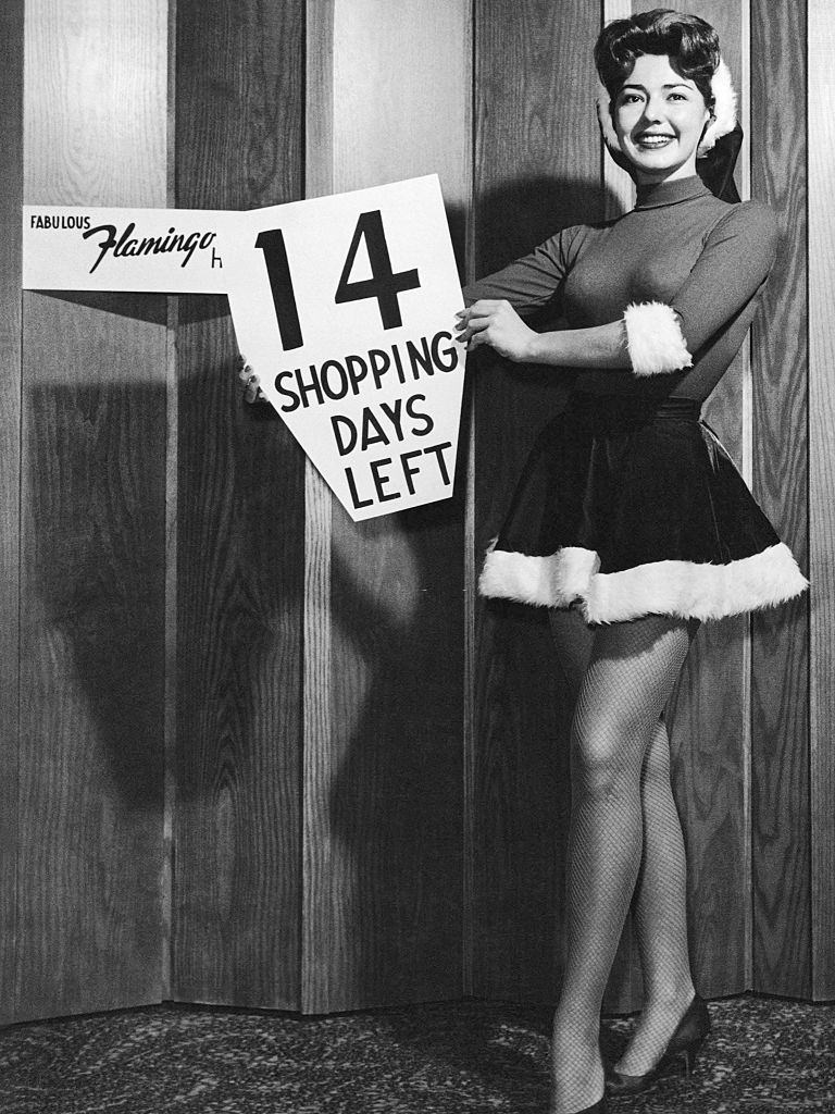 #54 A lovely Jean Gardner of the Flamingo Hotel reminds you that there are only 14 shopping days left before Christmas, Las Vegas, 1960s.