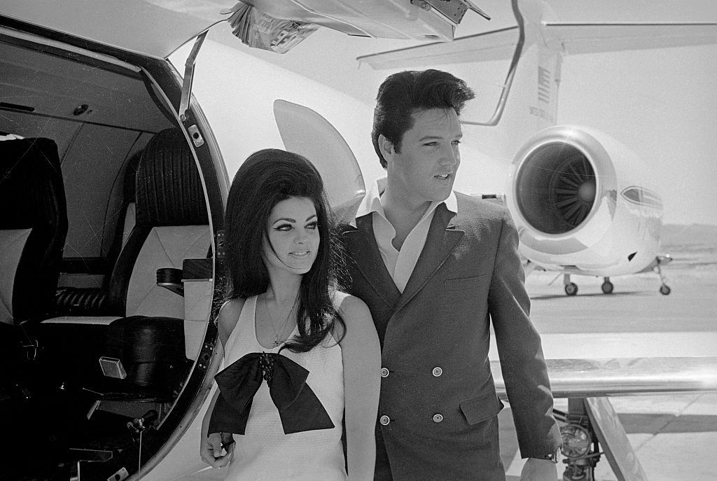 #67 Newlyweds Elvis and Priscilla Presley,prepare to board their private jet following their wedding at the Aladdin Resort and Casino in Las Vegas, 1967.