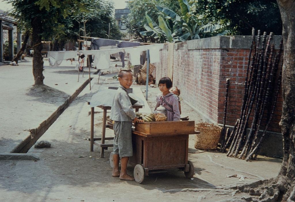 #4 A girl selling bananas from a sidewalk stall in Pingtung County, Taiwan, circa 1965.