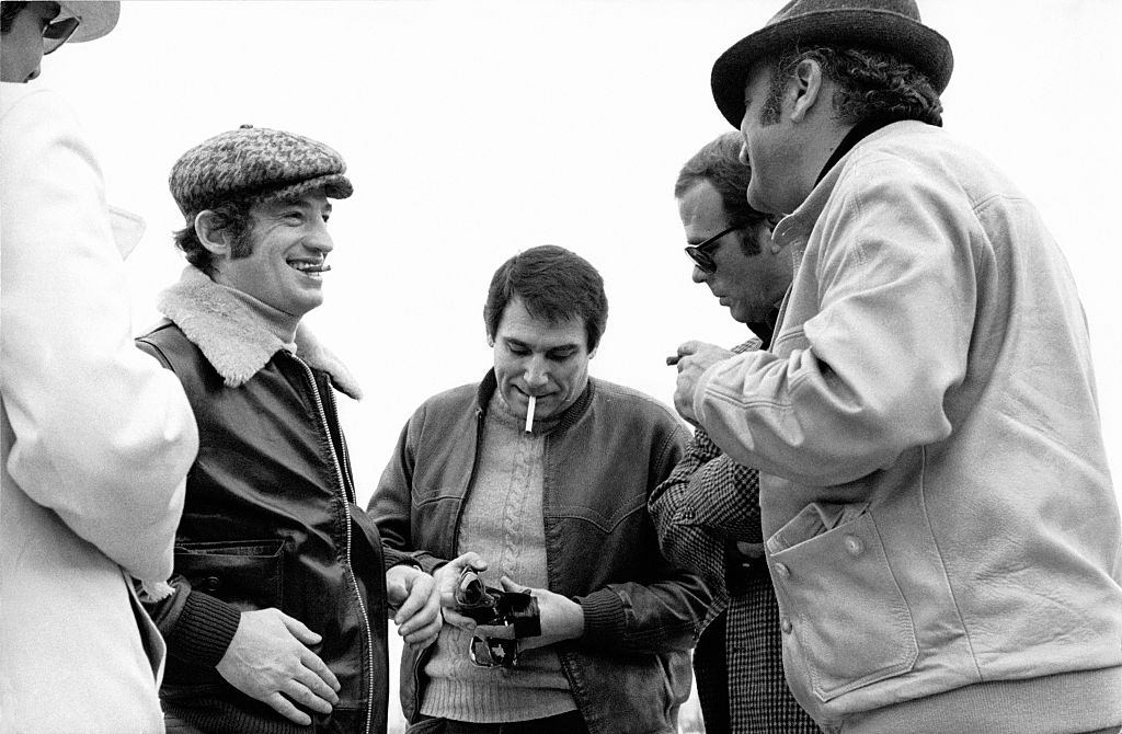 #24 Jean-Paul Belmondo and Robert Hossein on the set of the film ‘Le casse’ directed by Henri Verneuil in 1971 in Athens, Greece.