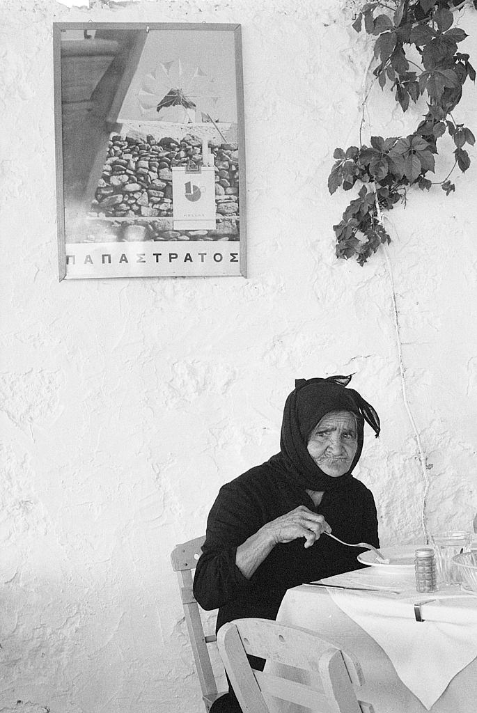 #3 An old woman eating seated in a restaurant. Greece, 1970s