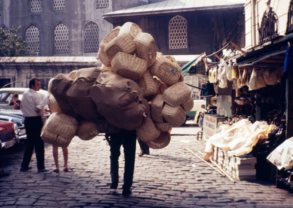 #6 A boy carries stacks of woven baskets on his back outside the Spice Bazaar known as Misir Carisi, Istanbul, 1971.