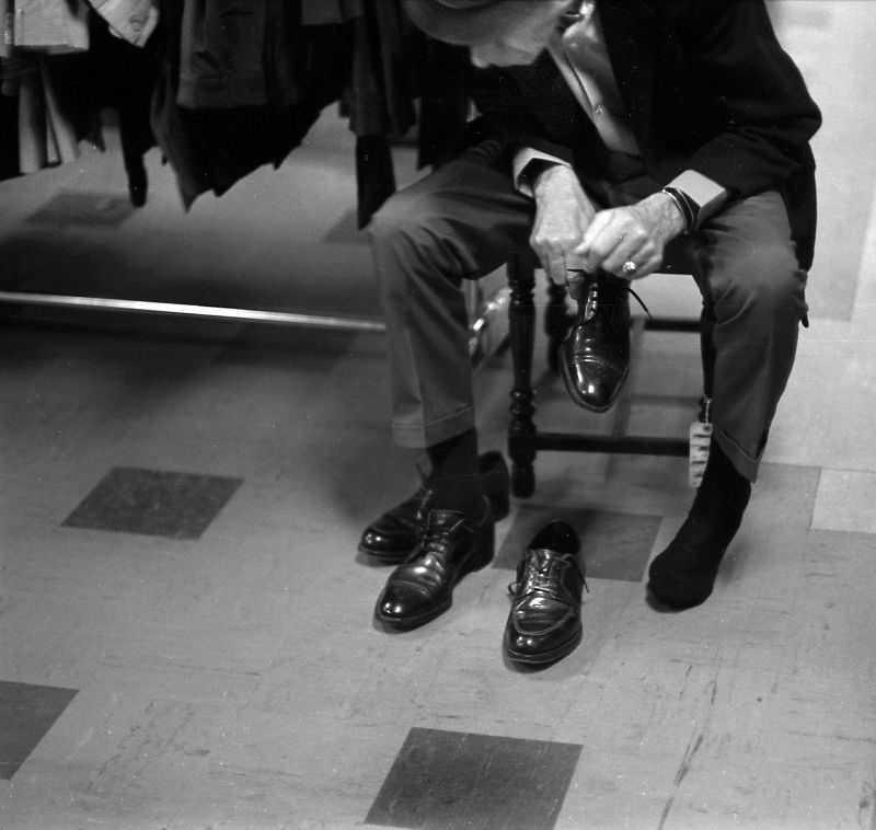 #77 Man trying on shoes at the Salvation Army store on Howard and 6th Street, San Francisco, 1970