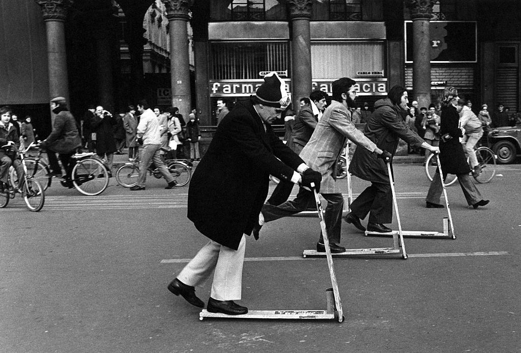 #14 People riding kick scooters on Piazza del Duomo in Milan, December 1973.
