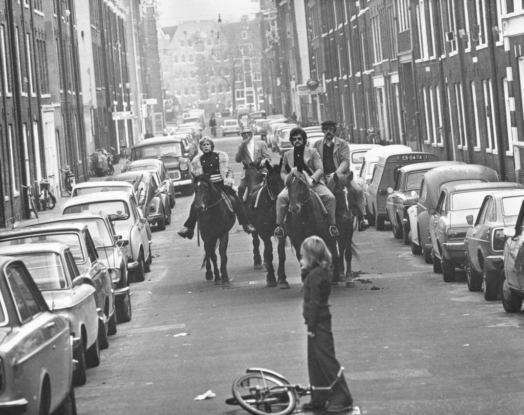 #27 Four horsemen riding through the streets of Amsterdam on a ‘motorless day’, when cars are prohibited due to the oil crisis, November 1973.