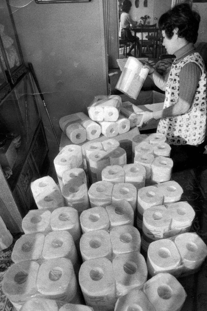#28 A woman purchases amounts of toilet rolls as oil crisis, Japan.