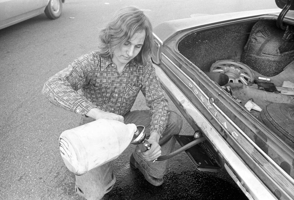 #4 Motorist pours gas into car from jug during ‘oil crisis,’ Boston, Massachusetts, 1973.