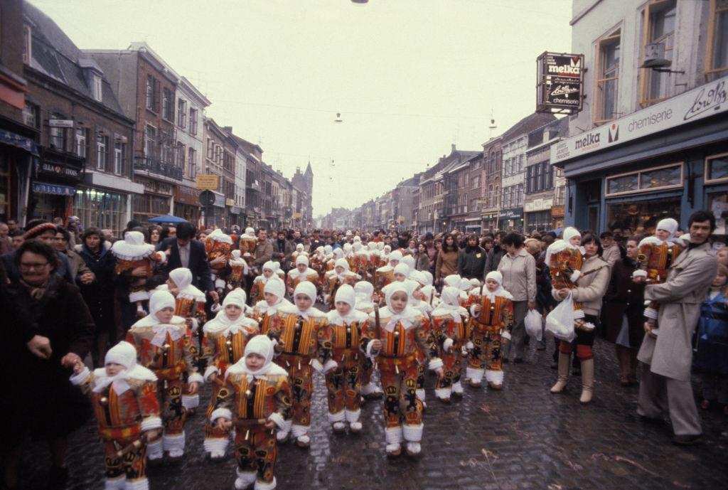 #1 Gilles parade wearing their wax mask during the Binche carnival, Belgium, 1980s.