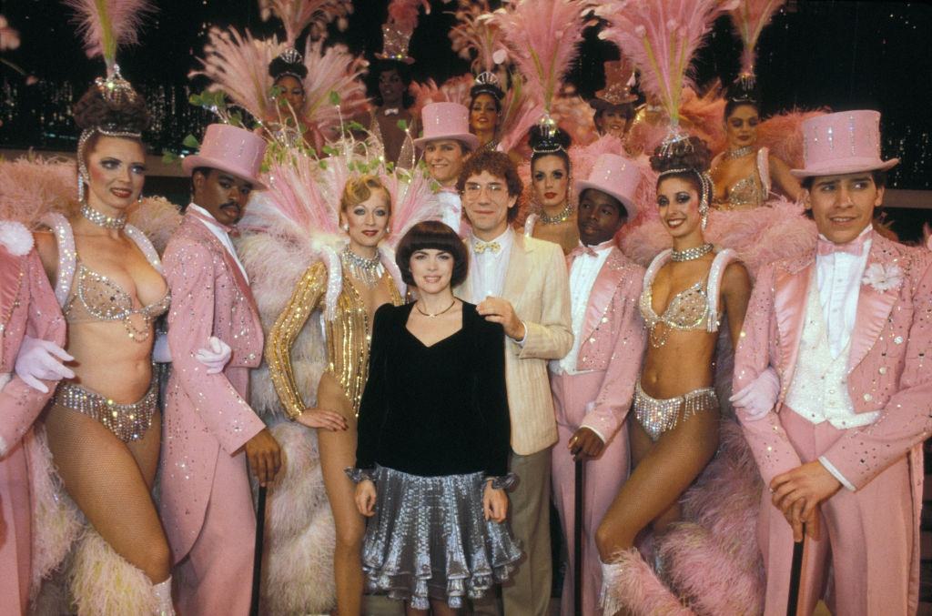 #45 Mireille Mathieu surrounded by dancers from the Moulin Rouge in Las Vegas on November 14, 1982.