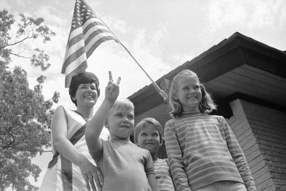 #9 Pat Collins (left) stands with the couple’s three children—Mike, 6; Ann, 7; and Kathleen, 10—on the lawn of their family home in Houston, Texas.