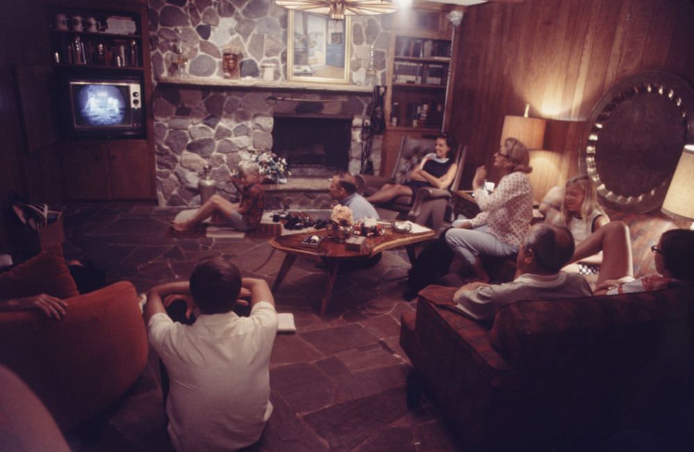 #14 Joan Aldrin (in polka dot white shirt) in the living room of their Texas home with sons, daughter and friends watching her husband’s moon mission via live T.V. transmission.