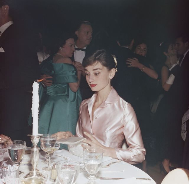 #18 Audrey Hepburn, at the Lido nightclub in Paris, 1955.