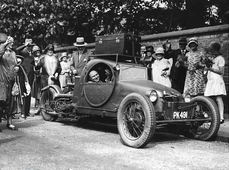 Mr. Graham’s novel three-wheel car designed to look like an armoured car, being used to take himself and his bride on honeymoon after their wedding.
